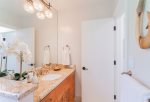 A remodeled full bathroom is located just off the family area and features a shower, and vanity with sink, tile flooring and granite counter tops